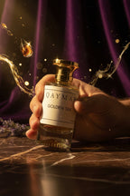 Golden silk perfume by Qaymar being handheld. extrait de parfum