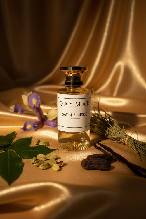Perfume bottle labeled 'Qaymar Satin Finesse' on a textured surface